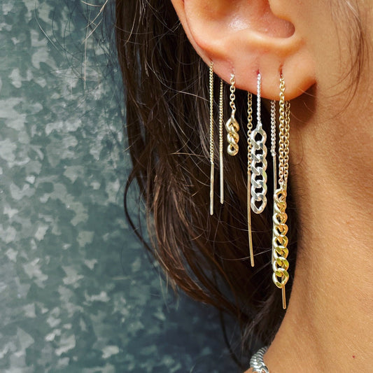 Gold and Silver chain pull through earrings on earlobe