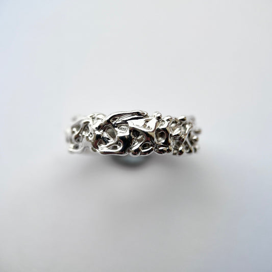 Silver thick band with organic texture on a grey background