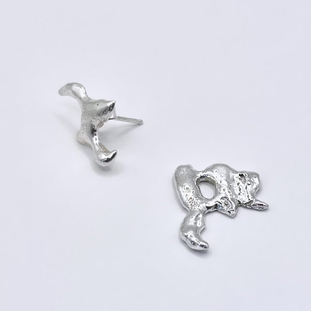 Photo of silver molten asymmetric earrings on a white background