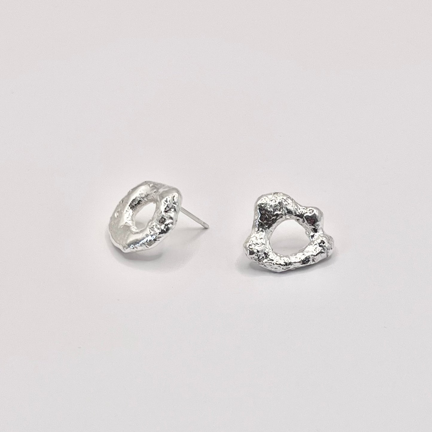 Photo of silver molten loop earrings on a white background